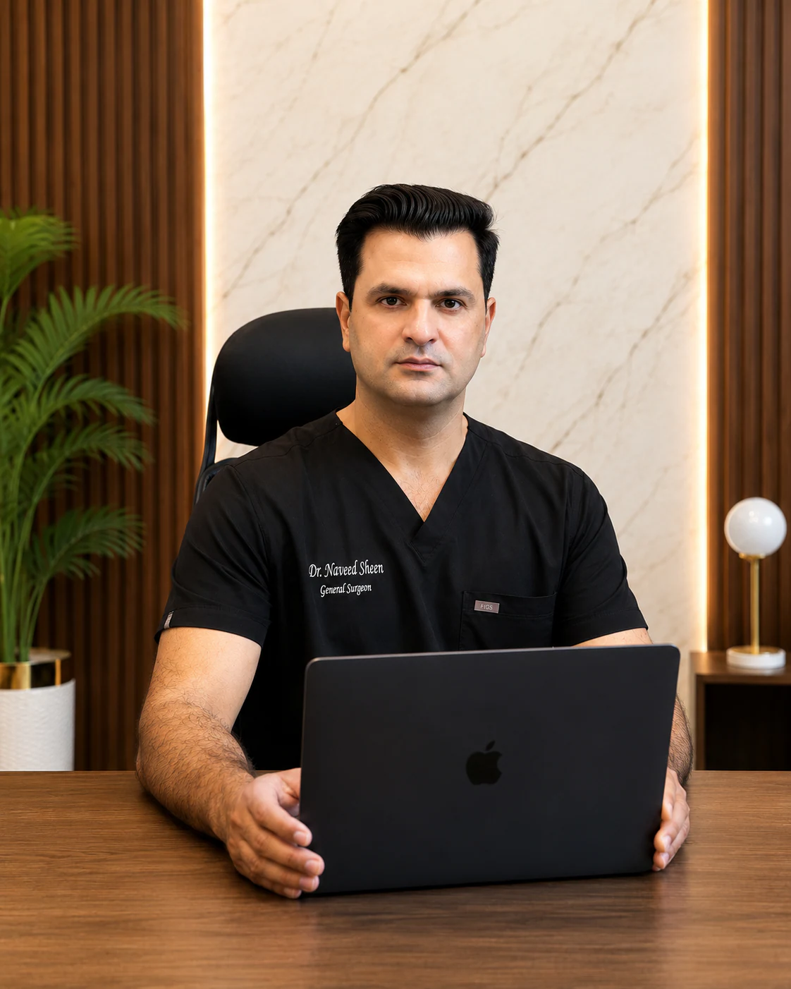 Dr. Naveed Ahmed Sheen at his clinic desk